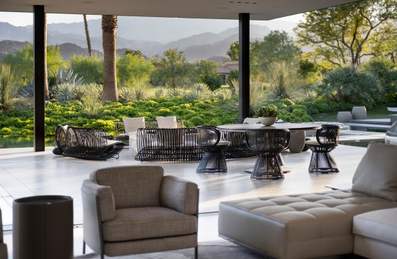 Serenity Indian Wells luxury modern home opens sliding glass walls to a covered outdoor terrace