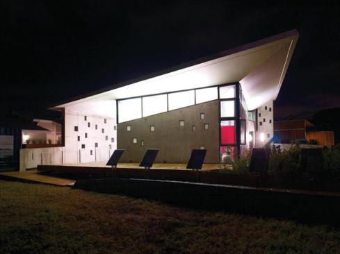 The house features a large, dramatic roof (which weighs 200,000 pounds and measures exactly 18 feet at its highest point), which was angled to create an inverted hip for collecting rainwater.