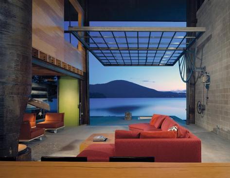 Tom Kundigs take on the casual lake lifestyle was a tough concrete box that can be left out in the weather without maintenance. The pivoting window wall turns the cabin into an open-air pavilion.