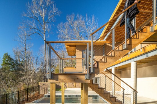 The staircase leading from the main living space down to the pool.