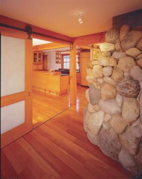 Ghost partitions marked with floorboards running against the grain, such as those shown between the living room and kitchen recall how the old house was subdivided.