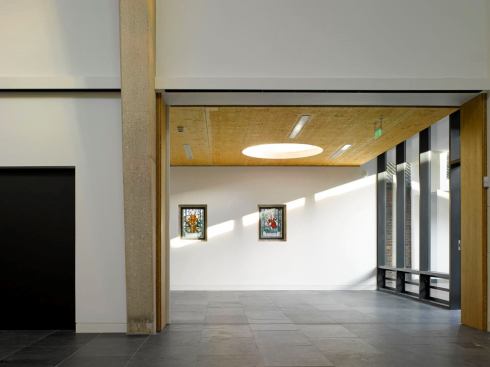View from the worship space into the East community room and garden beyond. Skylights and glazing in the East and West community rooms maximize the use of daylight for daytime functions.