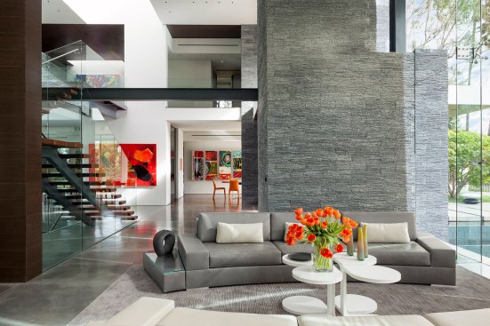 View from living room to dining room in open plan luxury modern Beverly Hills home. 