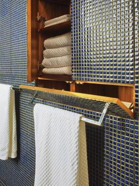 Clever built-ins and features such as a hidden hamper help the space live large.
