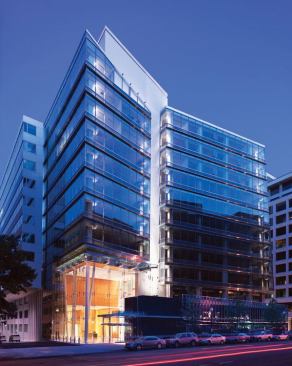 The Columbia Center differs from adjacent buildings on 15th Street in downtown Washington, D.C., with its glass fa&ccedil;ade. The lightbox lobby receives abundant natural light during the day and is visible from blocks away at night.