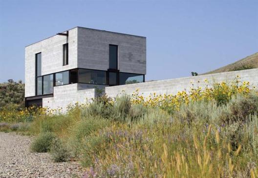 The compact concrete block shell was built quickly and inexpensively. Inside, the steel and recycled fir were left exposed and unfinished, resulting in little waste and low VOCs.