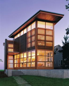 Angling the houses walls helped to break up the linearity dictated by a narrow lot. The diagonal wall and raised platform, which was designed to keep flood waters at bay, create a terraced entry court. Louvers diffuse the sun and the street view.