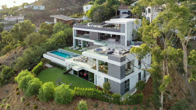 Los Tilos Hollywood Hills modern home with sliding glass walls for indoor outdoor living and sunset views. 