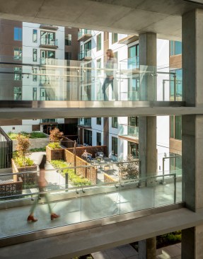 A layered stack of pedestrian bridges floats above the inner courtyard