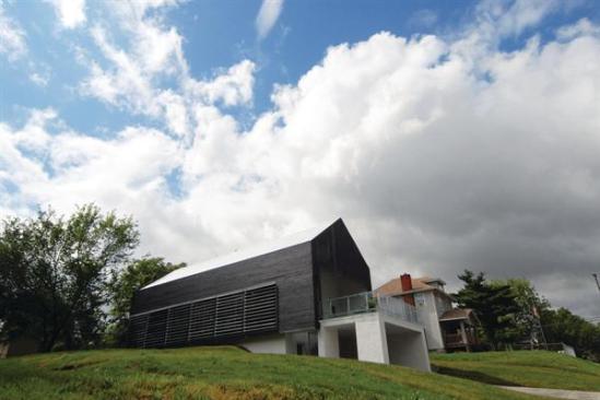 Louvers and a burned-wood skin clad the Prescott Passive House's exteriors.