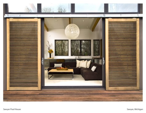 Entrance into the pool house, from the deck. Featuring the bi-parting sliding doors