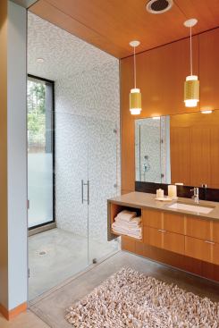 The shower at the room’s opposite end looks out on a quiet garden.