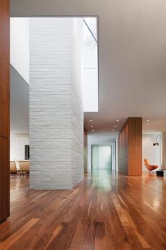 The original brick fireplace and skylight ring at the center of the house were exposed but otherwise left unchanged.