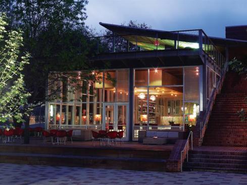The two-story restaurant?s north fa?ade is dominated by floor-toceiling glazing on the first level that offers ample views into and out of the main dining space. A broad brick staircase leads to a terrace on the second story that extends over the first floor with a cantilevered balcony.