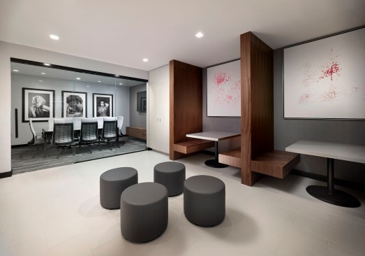 The 24-hour co-working and business center was designed with wooden work pods and a separate conference room with glass doors. 