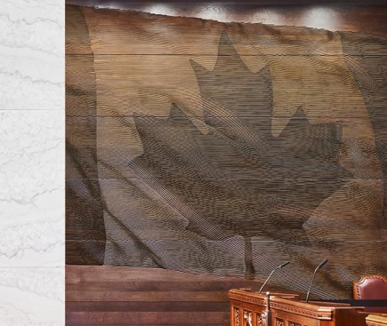 Two Canada flags carved in wood flank the Speaker's Throne in the Chamber. 