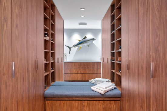 Dressing room with custom walnut built-ins.