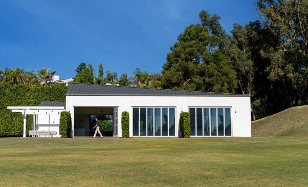 South facade with 11-foot tall folding doors allowing golfers to swing out of the building 