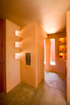 Mandeville Canyon modern home front door entrance with cutout portal windows and natural light