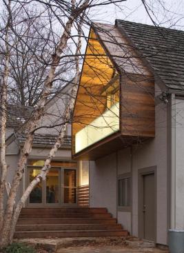 The cantilevered balcony offers a dry spot for the family dog on the steps.
