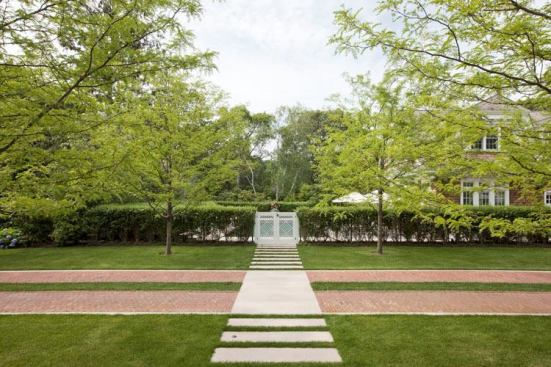 In contrast to a traditional mortared walkway, the pavers were inset in the lawn over crushed gravel, allowing rainwater to percolate down into the soil.