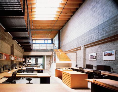 The new third-story mezzanine holds a kitchen/conference room at the top of the stairs.
