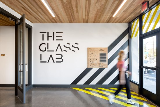 The creative space's industrial theme is expressed upon entry with this large-scale experiential graphic.