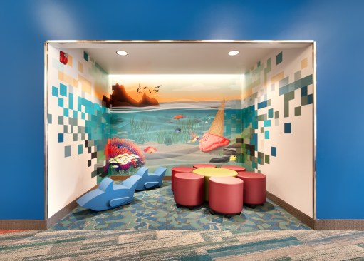 Whimsical custom graphics were developed by the team to reinforce the building theme of Imagination.  