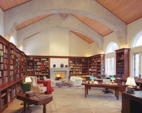 Custom Home, November-December 2004  Custom Touches  Limbacher & Godfrey Architects, Austin   Cherry bookshelves play off the pine ceiling and concrete arches of this Texas library to create a rich mix of textures.