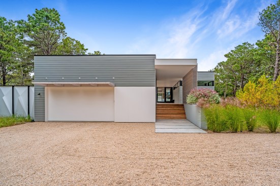 Approach from autocourt with site-built garage and covered breezeway entry.