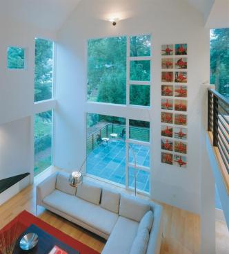 Glass panels in the great room capture the northern light and leafy backyard views.