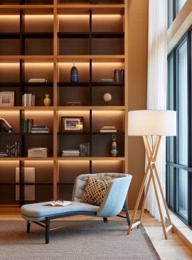Residents are surrounded by gorgeous statement bookshelves with open grid shelving and carefully curated accent pieces that interest the eye.