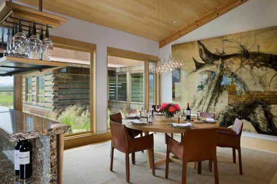 Interior, horizontal, dining room looking out windows to barn, Kahlbetzer residence, Wilson, Wyoming; Ward + Blake Architects