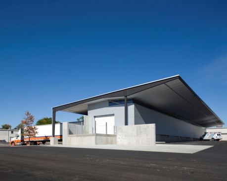 The distribution center is a simple 8500 square foot warehouse structure. A generous overhang protects the south facing galvalume skin from the hot summer sun while simultaneously providing shelter for loading and unloading. A shaded clerestory window allows indirect natural light to fill the warehouse interior.