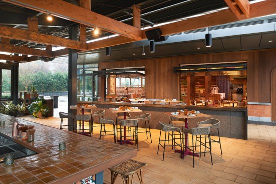 Outside, the hacienda-style area features woven accents, with terracotta and ceramic lights accenting the bar itself. A bright, richly-colored tile bar top provides a splash of color, and local fauna from Texas and Mexico provide a needed pop of greenery throughout.