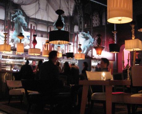 An additional backlit image appears over the bar to provide continuity and a visual screen for the color-changing back bar. A warm-white LED wall grazer that matches the low-voltage backlighting at the walls achieves this. Color-changing LED floodlights provide task-oriented white light or colored light to counter balance the image in the foreground.