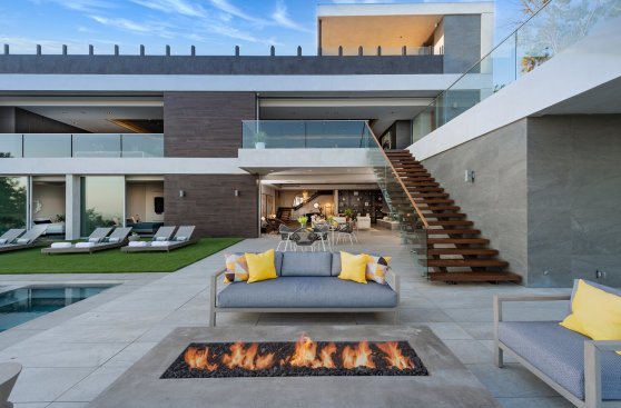 Driveway entry to rooftop parking at Hollywood Hills home with view.