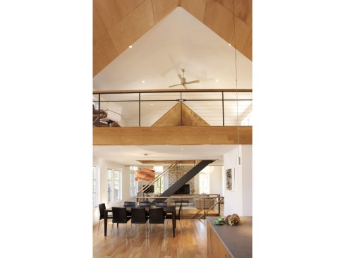Looking at the dining room, open staircase, and loft above