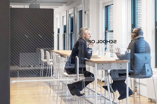 Open collaborative zone and kitchenette brings students, administration, and faculty together around a common table.