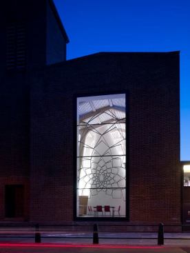 External view of the Church at dusk from Regent Square. The sanctuary space is illuminated by both direct and indirect lighting elements.