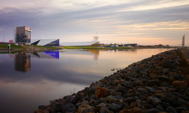 At 6 am the river is glass as the sun arrives on the horizon.  The boathouse “floats” in the water.  The Boathouse District has become a great place for family entertainment and healthy play.  