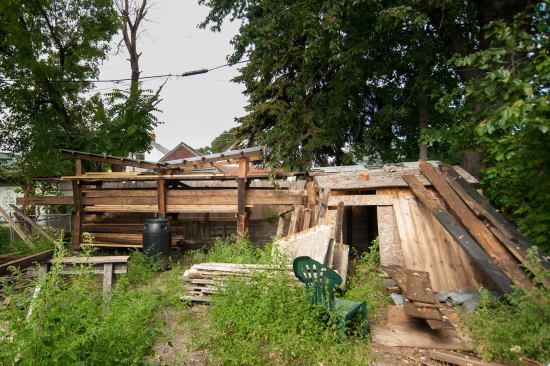Materials hand-salvaged from the existing house are stored in the backyard of the neighboring farmhouse.