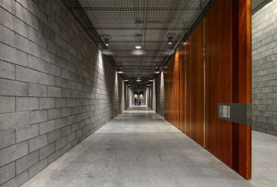 In the Collections Addition, which houses storage  and conservation facilities, the lighting designers wanted to create a contrast  to the lighting approach in the museum galleries. A metal-grate system hangs  below the ceiling so that the downlights, which have fluorescent fill, create  texture on the walls.