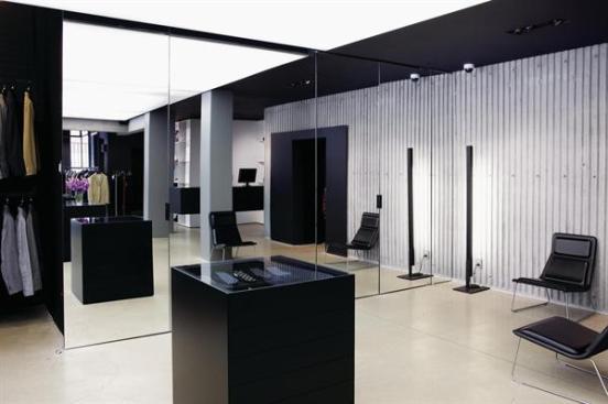 The smoked glass walls give way to conventional mirrors outside the changing rooms.