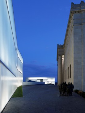Glowing boxes offer a bright contrast to the historic building.