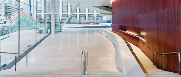 ... and the team exploited this to turn the space into an informal theatre-in-the-round for the passerby, who can sit on a grandstand or on shallow steps outside to watch the goings-on.