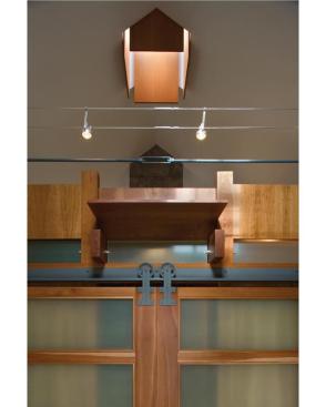 The bathroom, built like a piece of fine furniture, is brightened by a chimney skylight.