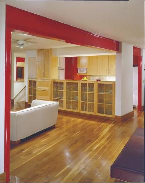 Within the cluster of new buildings, architect Bob Gurney marked the existing one with red paint. The color is carried inside on the steel beam that replaced a wall of the house.
