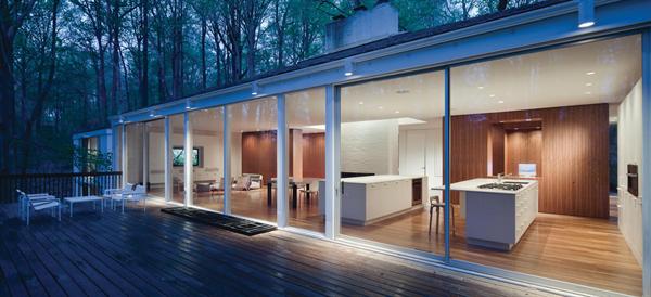 The glassy living spaces open to a full length deck.