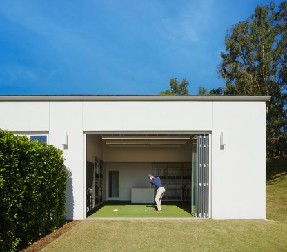 11-foot tall folding doors allowing golfers to swing out of the building down the 400-yard driving range
